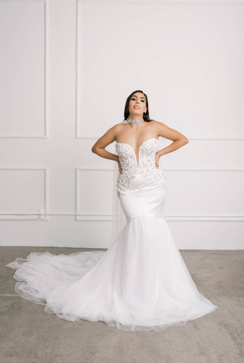 Bride wearing a luxury beaded strapless satin mermaid wedding dress by luxury bridal designer brand Lawrencia Bridal Couture