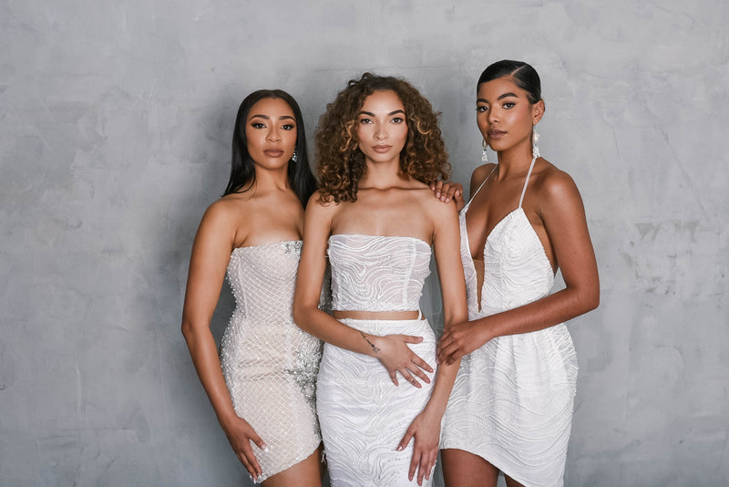 Three brides wearing luxury couture beaded wedding dresses in Los Angeles Bridal Shop