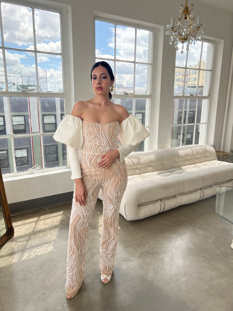 Latina bride wearing a pearl beaded luxury bridal jumpsuit with poof long sleeves perfect to wear to your wedding reception bridal shower or bachelorette party