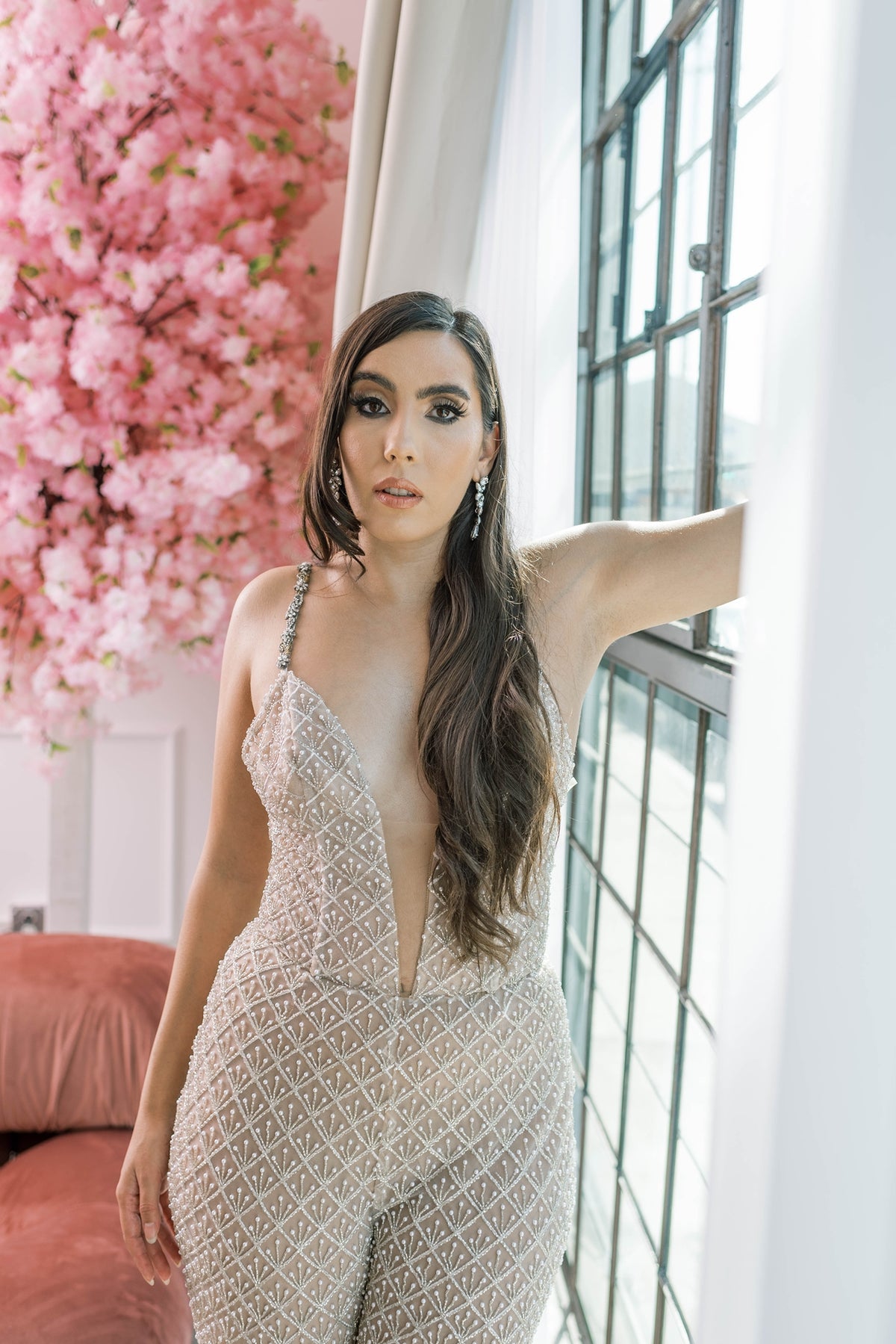 Bride wearing luxury beaded wedding jumpsuit with a sleek, modern fit that highlights her curves