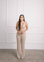 Modern bride in sexy beaded jumpsuit with Swarovski crystal straps, low back & plunging neckline.