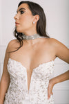 Up close view of jewel studded and soft off-white tulle wedding cape