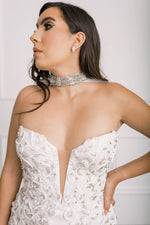 Up close view of jewel studded and soft off-white tulle wedding cape