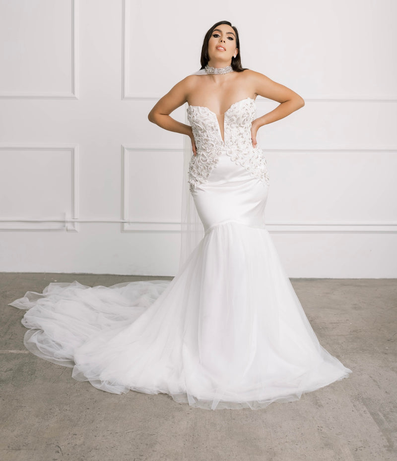 Bride in the wedding cape, with Swarovski crystals, flowing back panels and a soft off-white English tulle netting