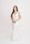 Bride trying on a mermaid fit and flare wedding gown that gives her a sleek, streamlined silhouette