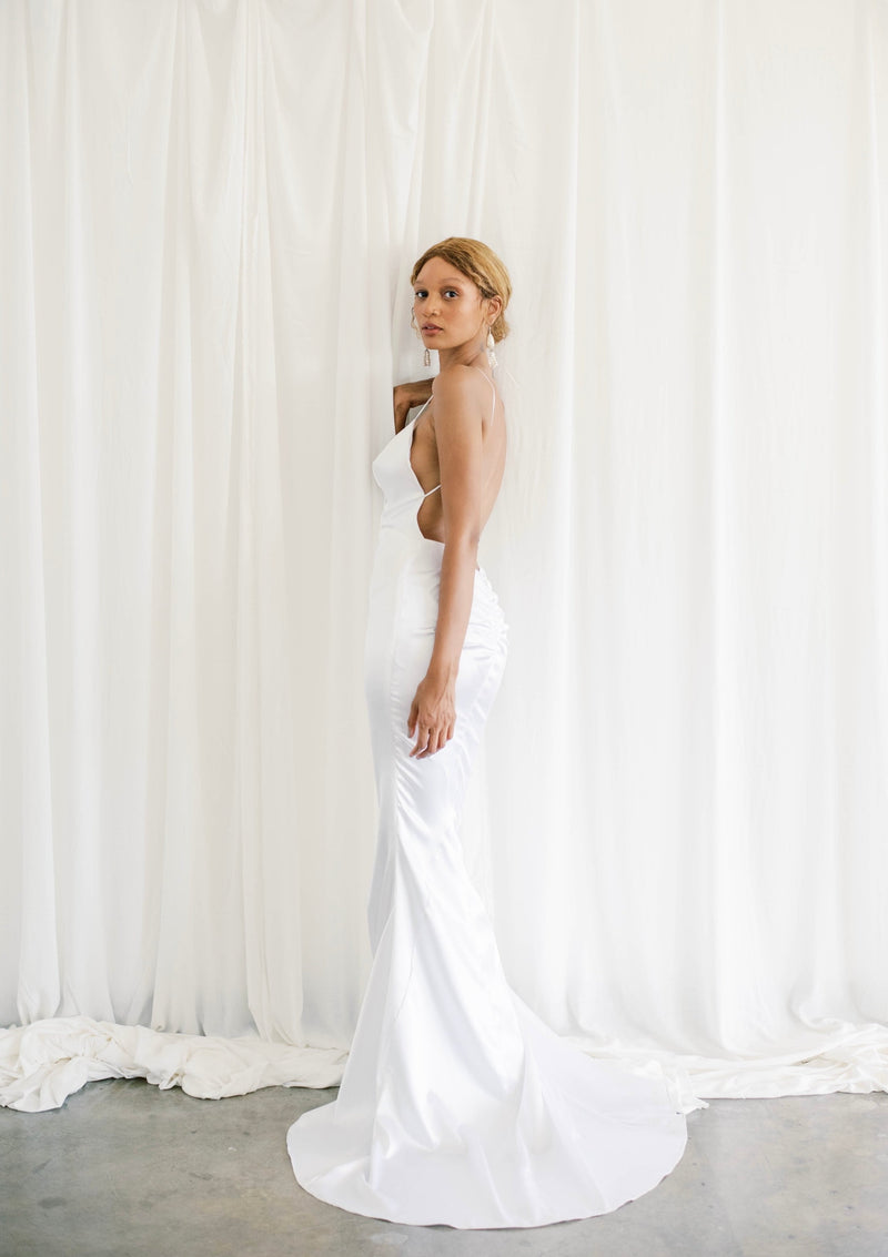Glamourous bride wearing hollywood-style wedding dress with plunging low back